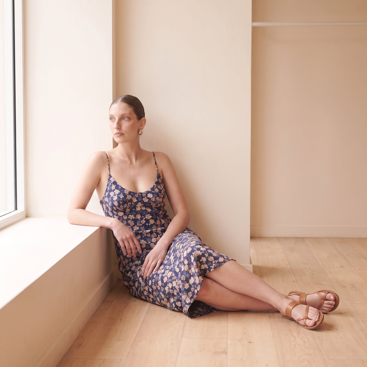 Celeste navy floral slip midi dress seated by Riley Belle