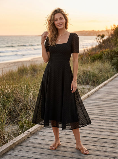 Black swiss dot cocktail midi dress by Riley Belle