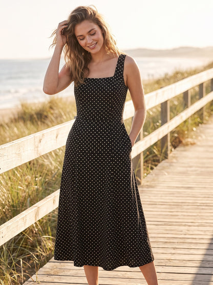 Black polka dot wedding guest midi dress by Riley Belle