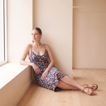 Celeste navy floral slip midi dress seated by Riley Belle