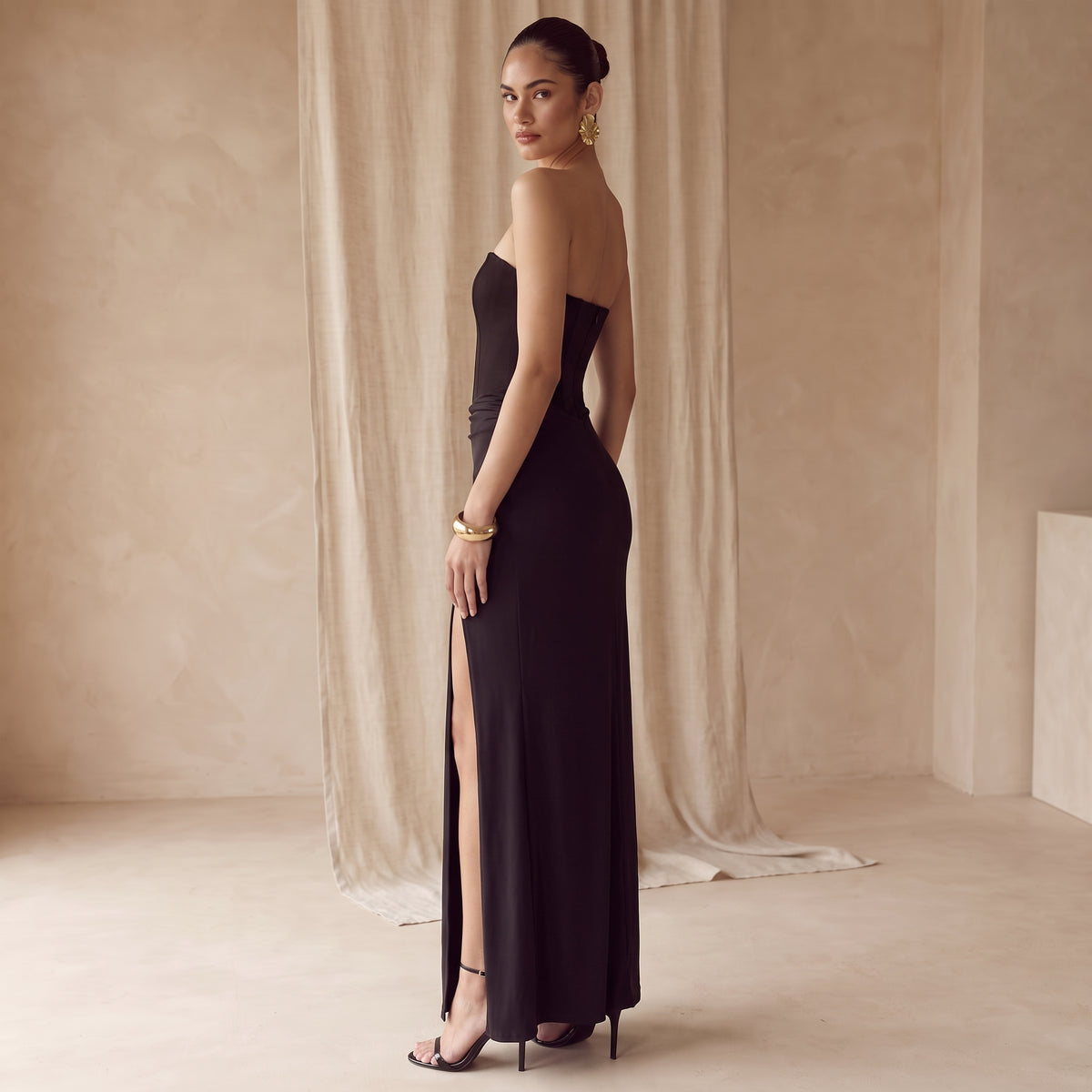 Anouk black corset high-split maxi dress side view by Riley Belle