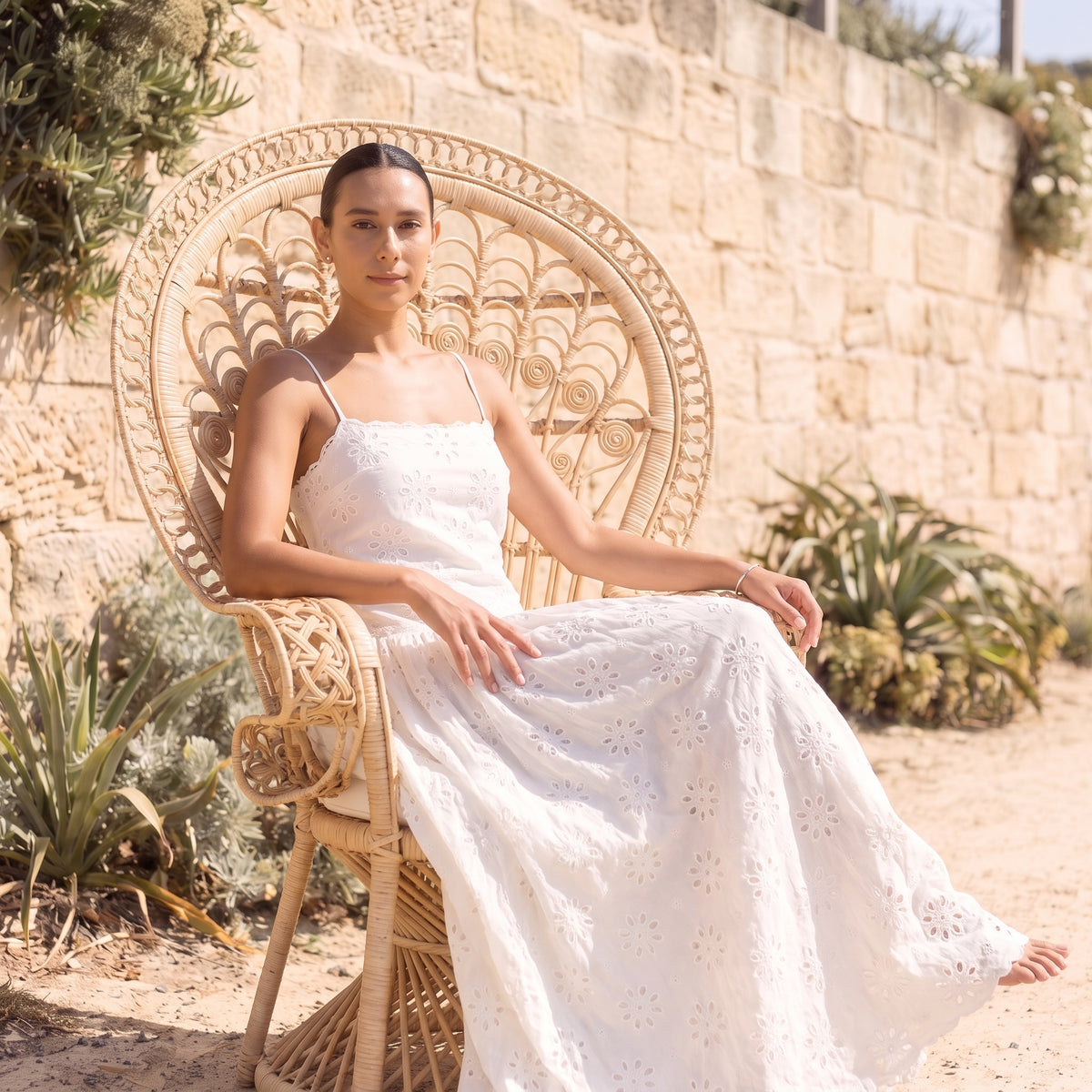 Isla white broderie maxi dress seated by Riley Belle